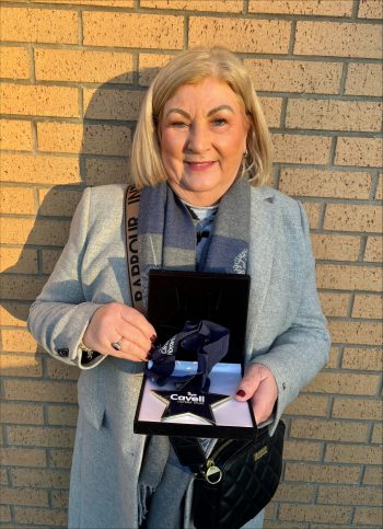 An image of a midwife receiving an award