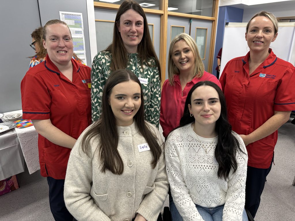 Four new midwives pictured with two ward managers in uniform