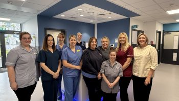 A group of nine healthcare staff pictured within the Ambulatory Cardiology Unit