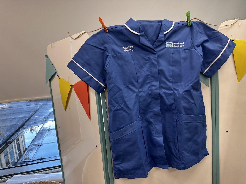 Midwife uniform hung on pegs