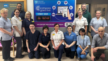 Staff at Daisy Hill Hospital stand beside the encompass countdown clock at the hospital entrance.