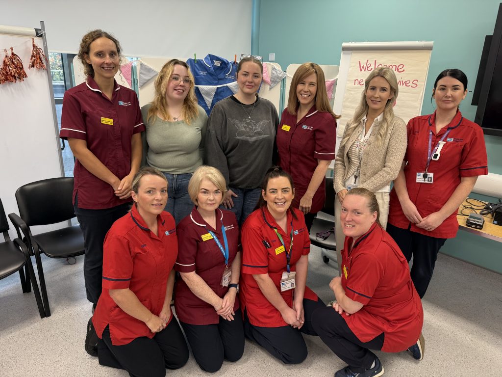 Pictured are 10 midwives standing and sitting