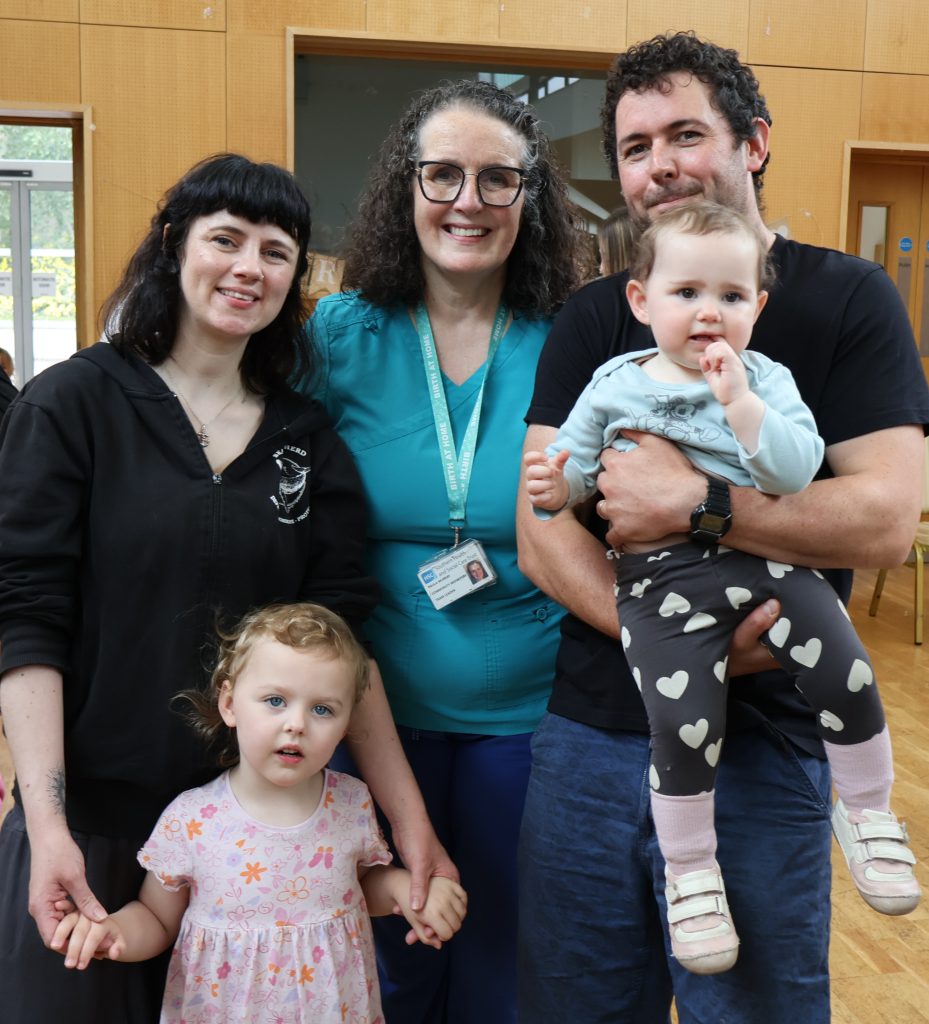 Eimear & family with Midwife Paula